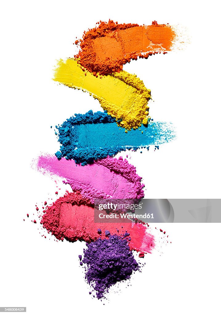 Make-up powder in different colours in front of white background