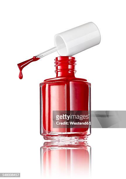 bottle of red nail polish in front of white background - nail polish stock pictures, royalty-free photos & images