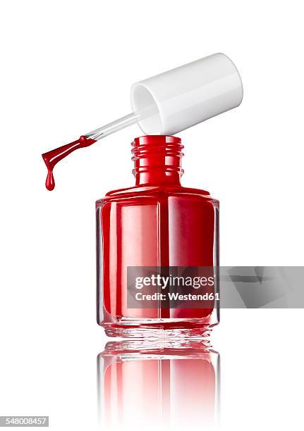 bottle of red nail polish in front of white background - nail varnish stock pictures, royalty-free photos & images