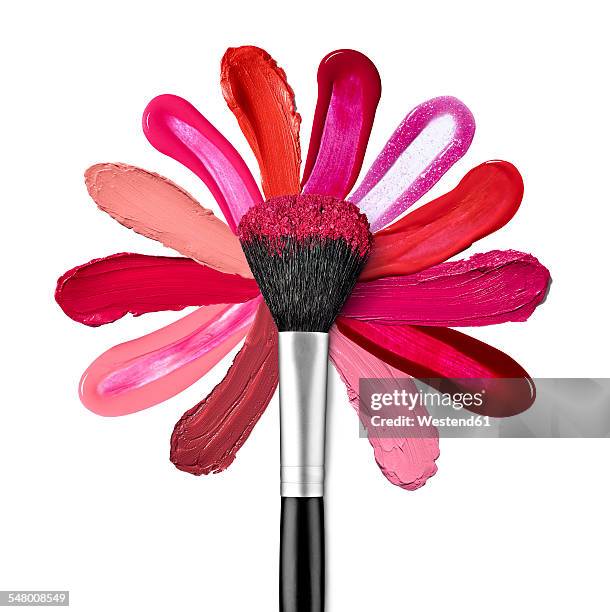 lipstick and nail polish strokes forming with powder brush a flower shape - makeup brush stock-fotos und bilder