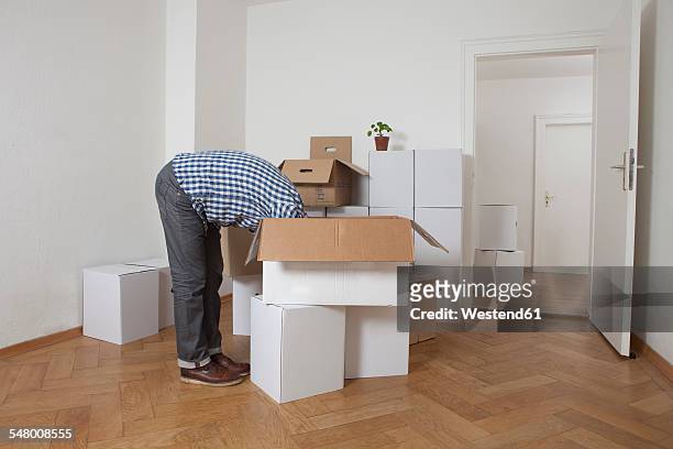 man searching head first in cardboard box - search new home stock pictures, royalty-free photos & images