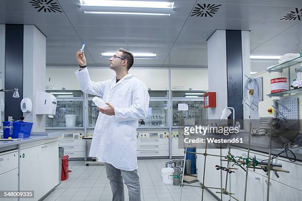 chemist working in lab looking at test tube - three quarter length stock pictures, royalty-free photos & images