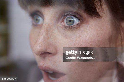 Frightened woman behind window Frightened woman behind window