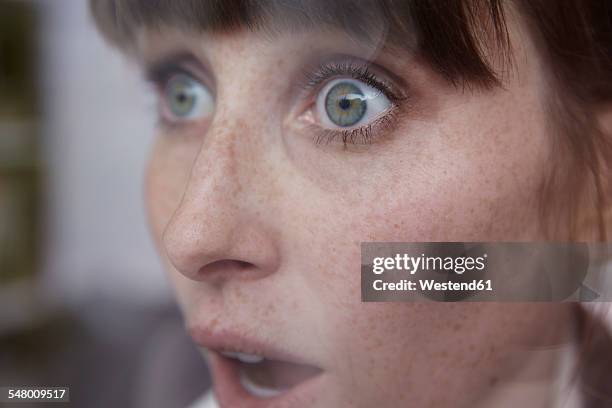 frightened woman behind window - shock imagens e fotografias de stock