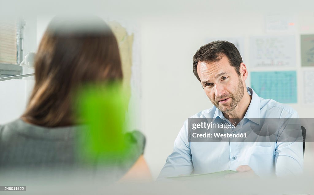 Businessman and woman in office