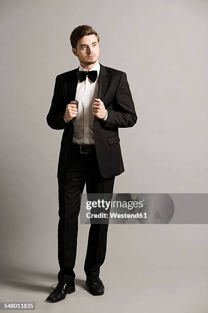 portrait of young man wearing black suit, white shirt and bow - black lapel stock pictures, royalty-free photos & images