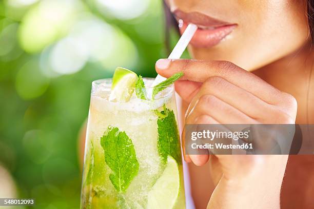 woman drinking mojito, partial view - straw lips stock pictures, royalty-free photos & images