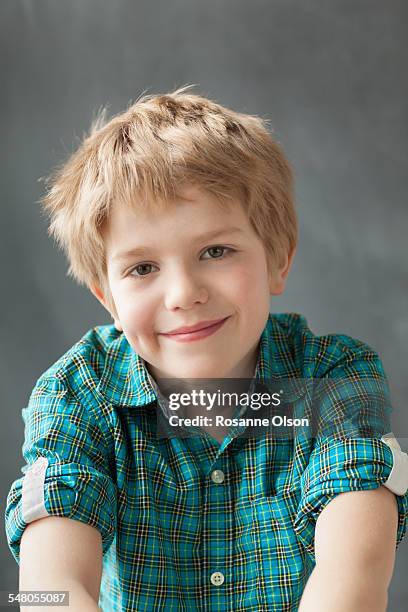 contented young boy in the studio. - rosanne olson stockfoto's en -beelden