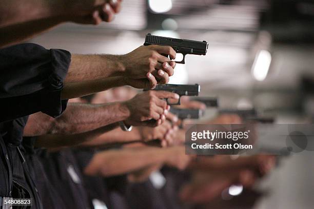 Iraqi Police learn to shoot a 9mm pistol at the Jordan International Police Training Center September 3, 2005 in Amman, Jordan. About 300...