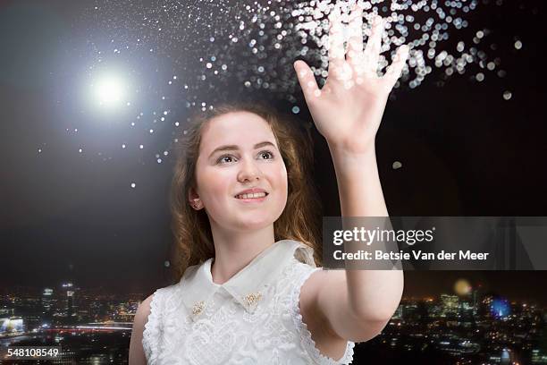 woman touches energy star dust in sky at night. - reach stars stock pictures, royalty-free photos & images