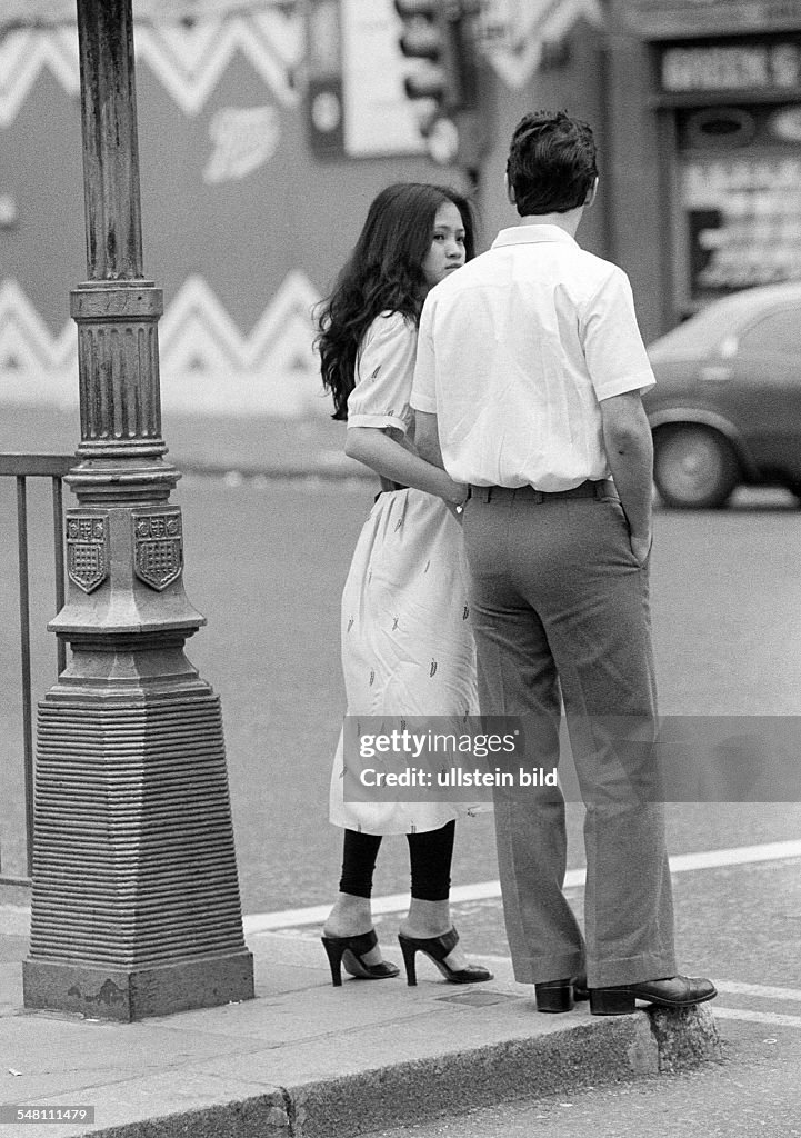 People, young couple stands at a street corner, hand in hand, aged 20 to 30 years, Great Britain, England, London - 02.06.1979