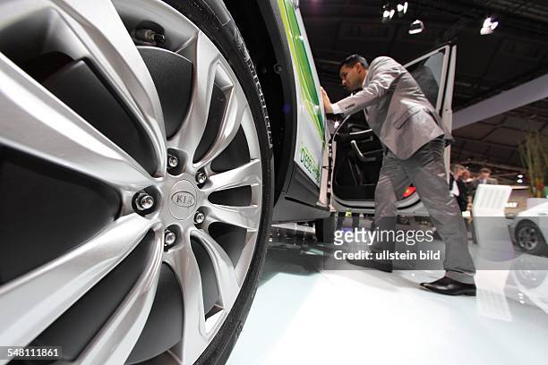 Germany Hesse Frankfurt am Main - 63th International Motor Show : visitor is interested in a car of the manufacturer Kia