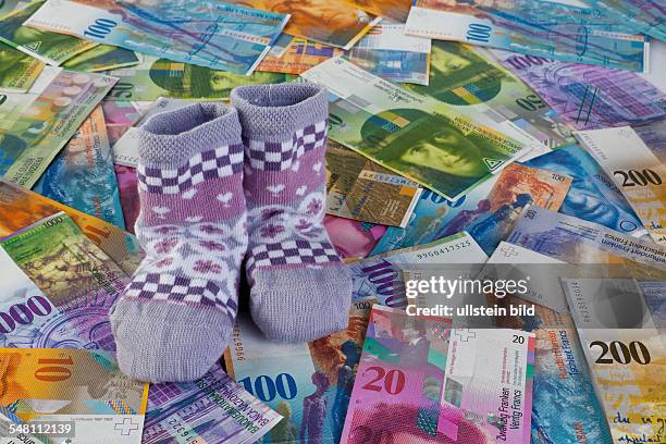 Baby socks and Swiss Francs banknotes