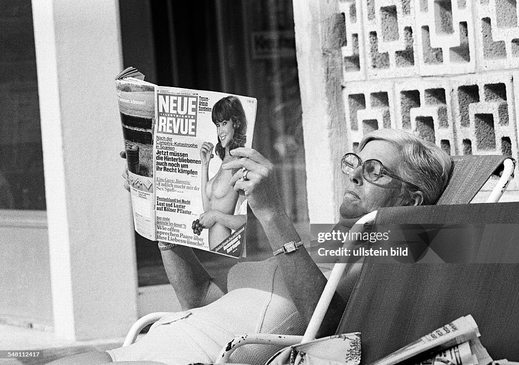 People, woman in a deckchair reads a magazine, sunbath, swimsuit, aged 50 to 60 years, Spain, Balearic Islands, Majorca - 10.10.1978