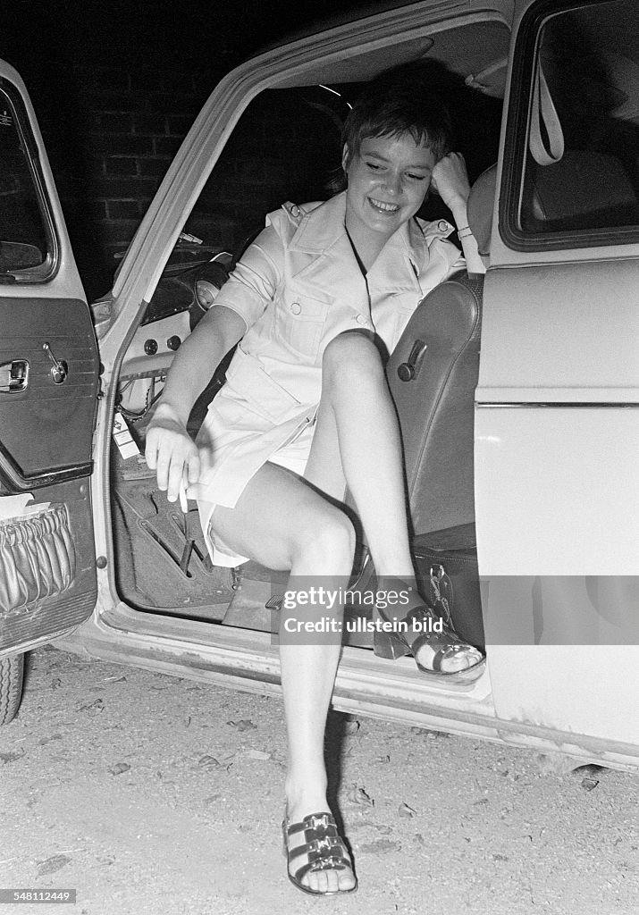 People, young woman poses in a car, drivers seat, opened drivers door, costume, miniskirt, bare legs, aged 20 to 25 years, Monika - 30.06.1970