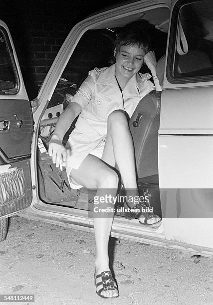 People, young woman poses in a car, drivers seat, opened drivers door, costume, miniskirt, bare legs, aged 20 to 25 years, Monika -