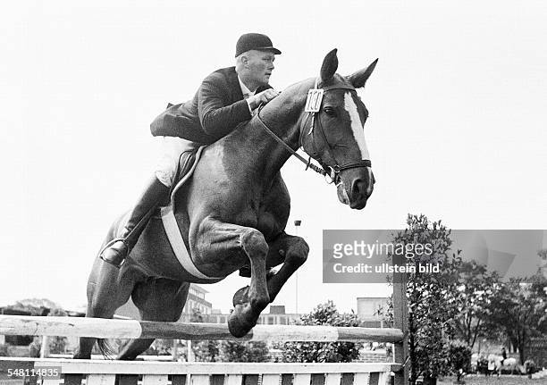 Sports, equestrianism, horse show 1965 in Bottrop, show jumping, horse and horseman jump over a barrier, aged 30 to 40 years, D-Bottrop, Ruhr area,...