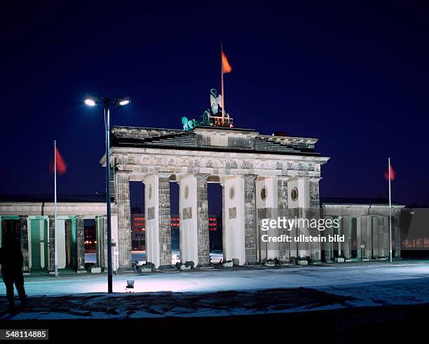 German Democratic Republic Bezirk Berlin East Berlin - "Brandenburg Gate" with Berlin wall in the foreground. Night shot