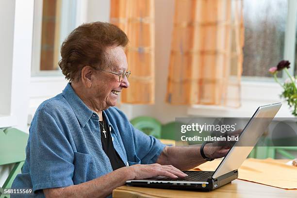 Elderly woman with laptop -