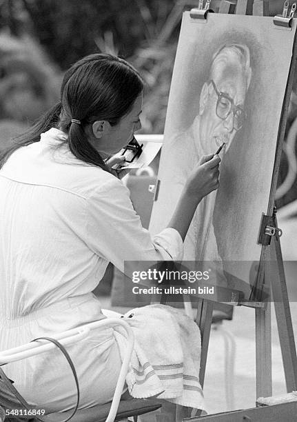 Culture, art, painting, young woman sits in front of an easel and paints a picture, aged 20 to 30 years, Spain, Canary Islands, Canaries, Tenerife,...