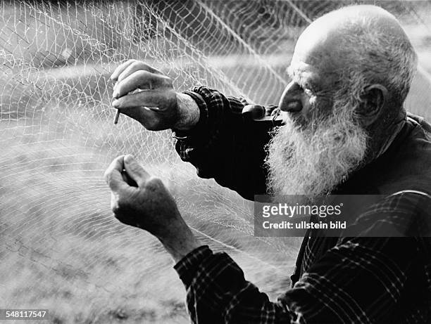 Germany Bavaria Regensburg - Old fisherman repairing his fishing net - 1950ies