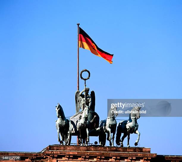 German Democratic Republic Bezirk Berlin East Berlin - The "Quadriga" on "Brandenburg Gate" with national flag of GDR.