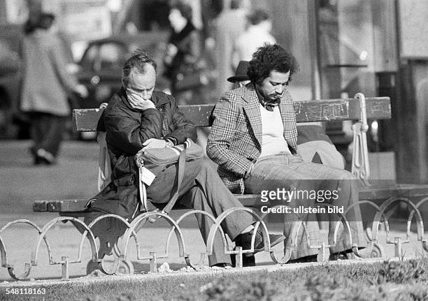 People, two men sit side by side on a bench, both are very depressed and tearily, aged 25 to 30 years, aged 30 to 40 years, France, Paris -