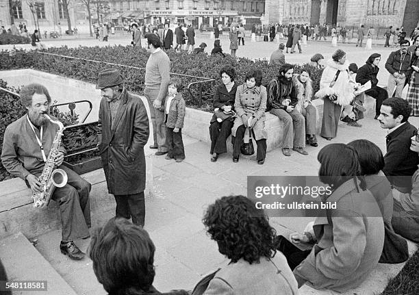 Culture, music, people sit on a public square and listen to a saxophonist, older man, aged 50 to 60 years, France, Paris -