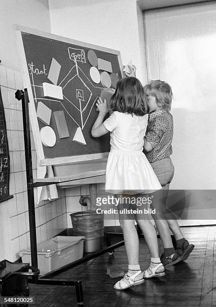 Edification, school, schoolboys and schoolgirls in a school class during lessons, children aged 7 to 10 years, boy and girl at a blackboard -