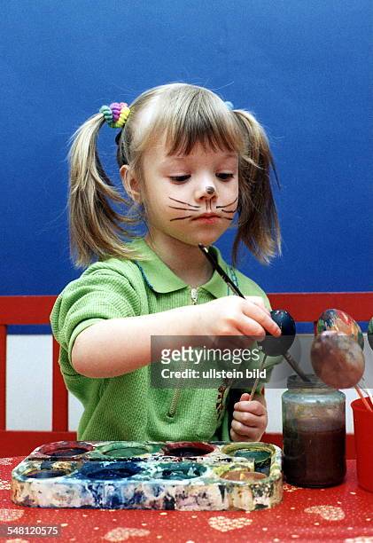 Girl preparing Easter eggs. 1997