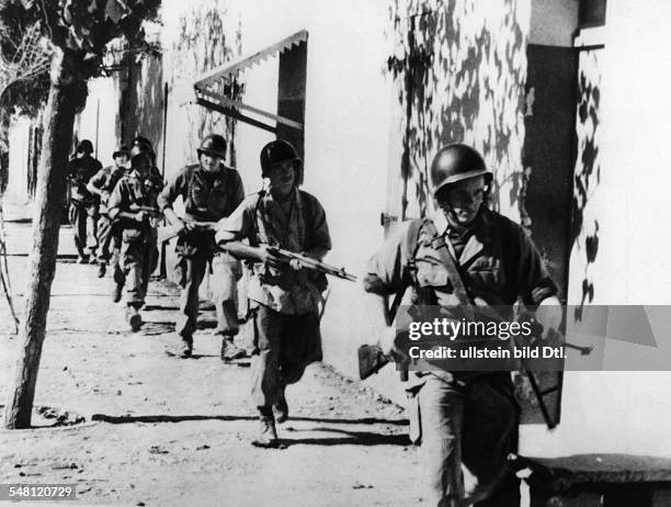 Algerienkrieg: Französische Fallschirmjäger durchkämmen ein Dorf im Bergland. O.O. November 1954