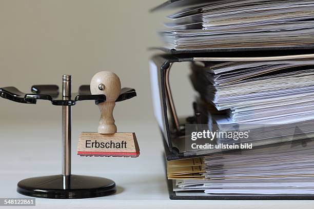 Germany - Stamp with inscription - Erbschaft - next to a pile of files