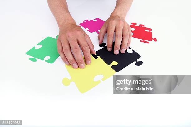 Germany - symbolic photo political coalition, Puzzle pieces in different colours symbolize German parties: coalition of CDU and FDP