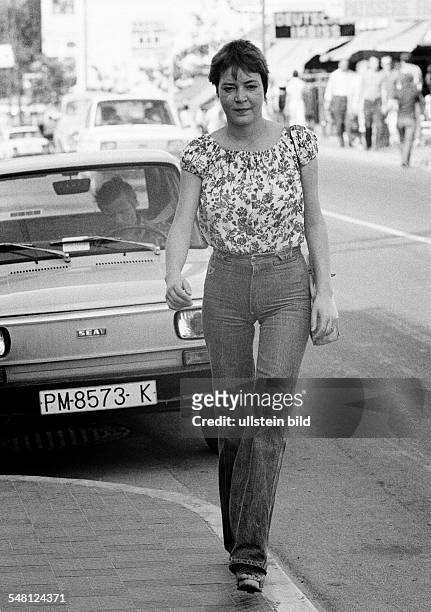 People, young woman on the pavement, blouse, jeans trousers, parking car, aged 22 to 28 years, Spain, Balearic Islands, Majorca, Palma de Majorca -