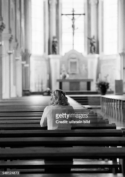 Religion, Christianity, young woman kneels in a pew and prays, aged 30 to 35 years, Elisabeth -