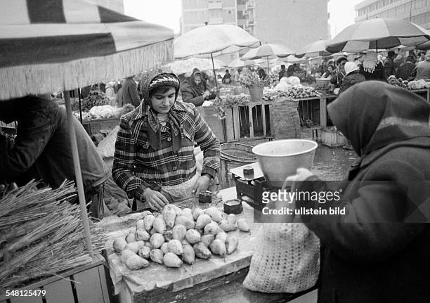 People, weekly market, market stall with fruit and vegetables, market woman, aged 25 to 30 years, Rumania, Romania, Bucharest -