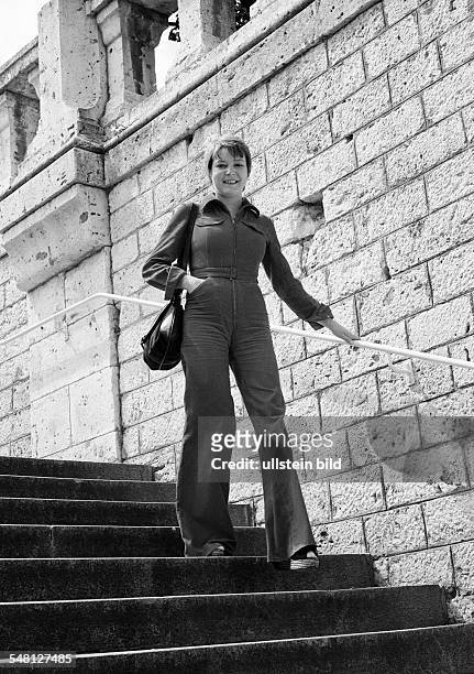 People, young woman on a staircase, stone stairs, handrail, wall, trouser suit, aged 25 to 30 years, France, Loire Valley, Loir-et-Cher, Blois -