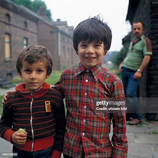 Germany North Rhine-Westphalia Oberhausen - children of a guest-worker pose in front of the mining settlement Eisenheim, two boys -