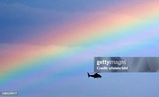 Helicopter in front of a rainbow