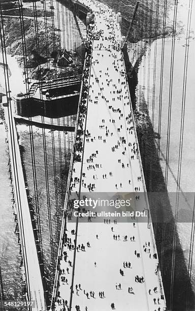 California San Francisco: Opening of the Golden Gate Bridge: view from a pillar of pedestrians on the bridge - June 1937 - Vintage property of...