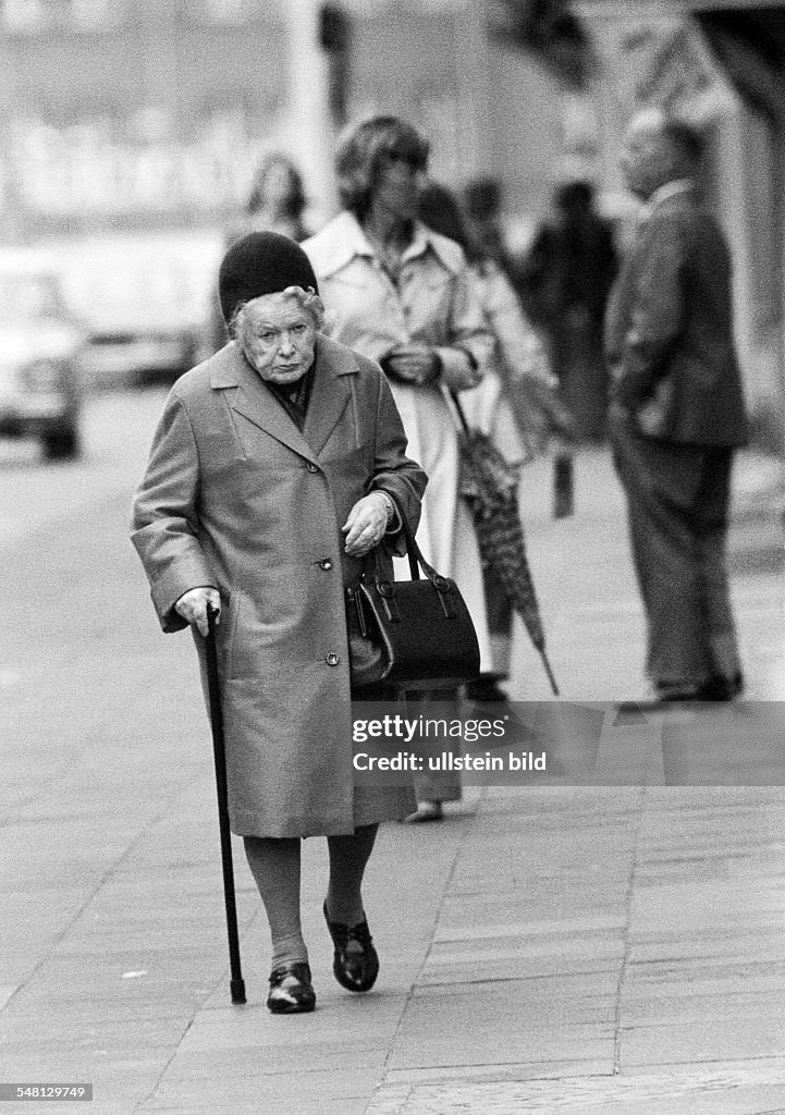 People, older people, older woman with a walking stick takes a walk, aged 70 to 80 years - 31.03.1976