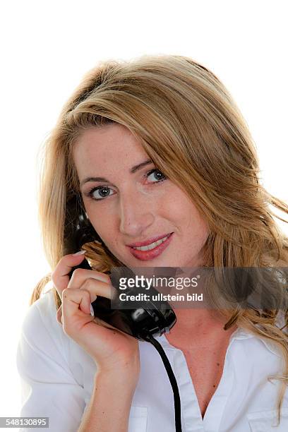 Woman making a phone call with an old telephone -