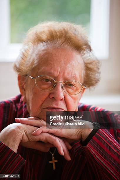 Elderly woman is contemplative and apprehensive -