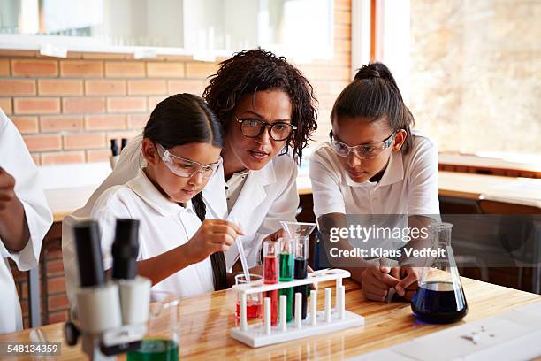 teacher assisting students with science project - children in a lab stock pictures, royalty-free photos & images