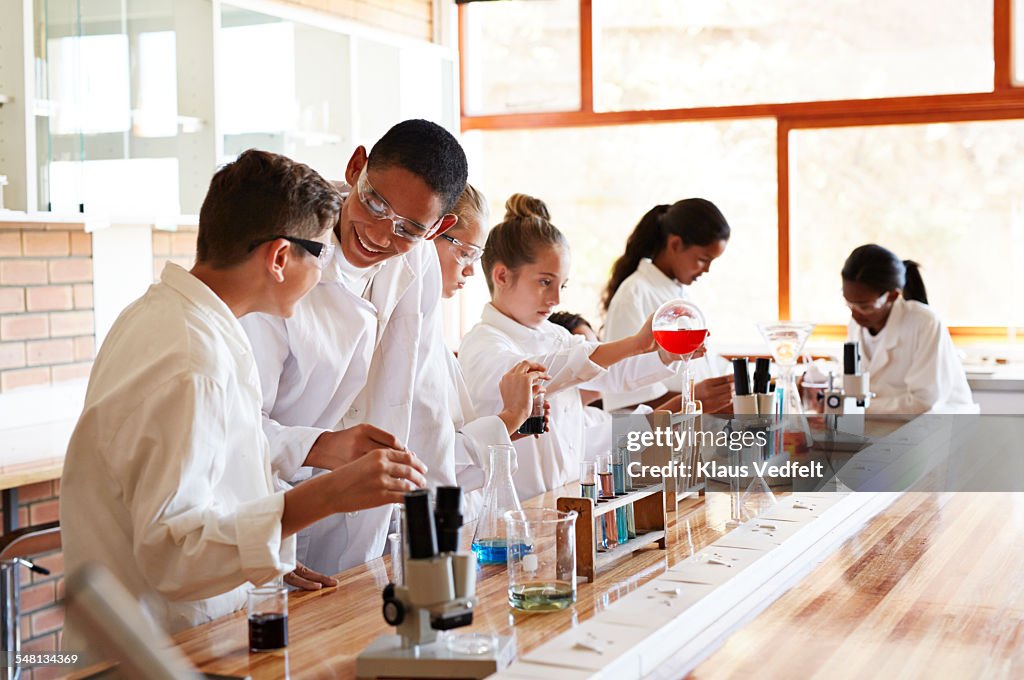 Students laughing while doing science projects