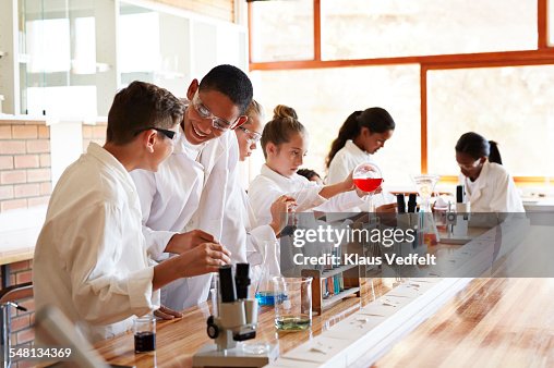 Students laughing while doing science projects Students laughing while doing science projects