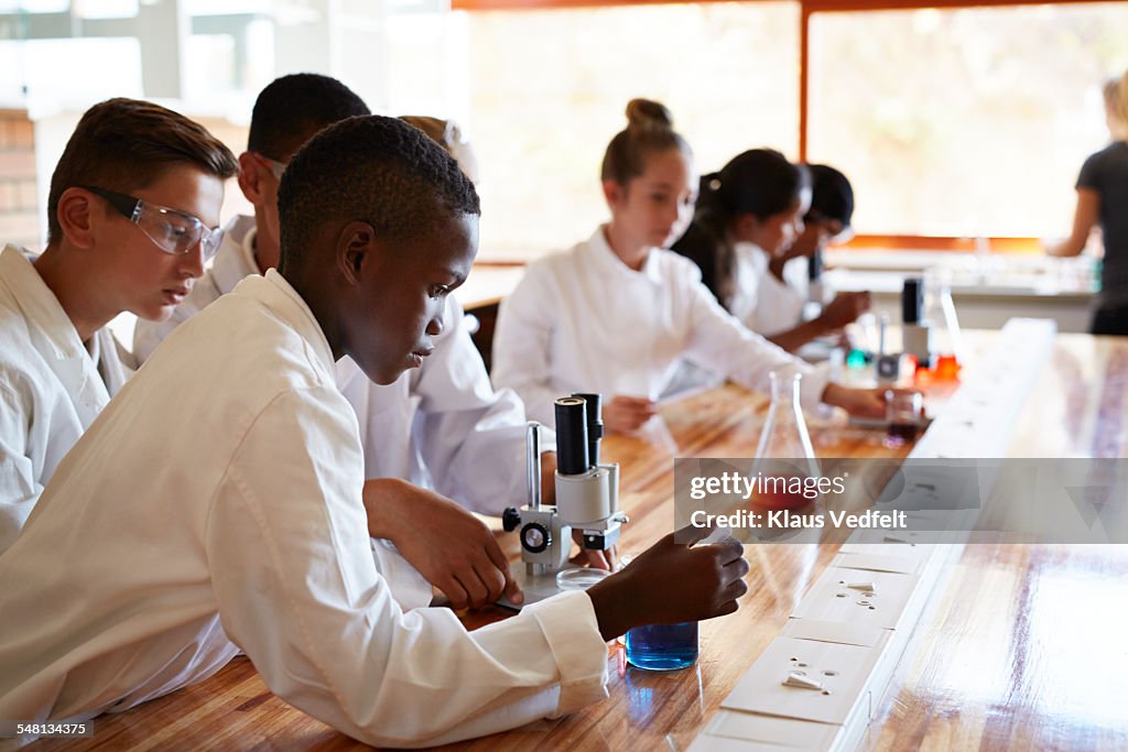 Student doing experiment with pipette & liquid