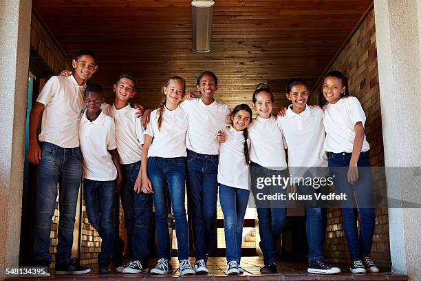 group shot of young school students - boy jeans stockfoto's en -beelden