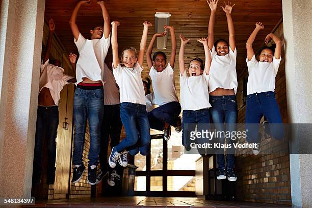 group of happy students jumping up in the air - 13 years old girl in jeans stock pictures, royalty-free photos & images