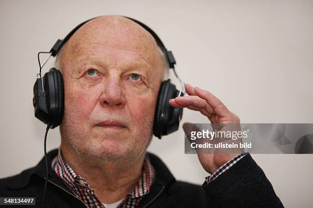 Elder man is listening to music -